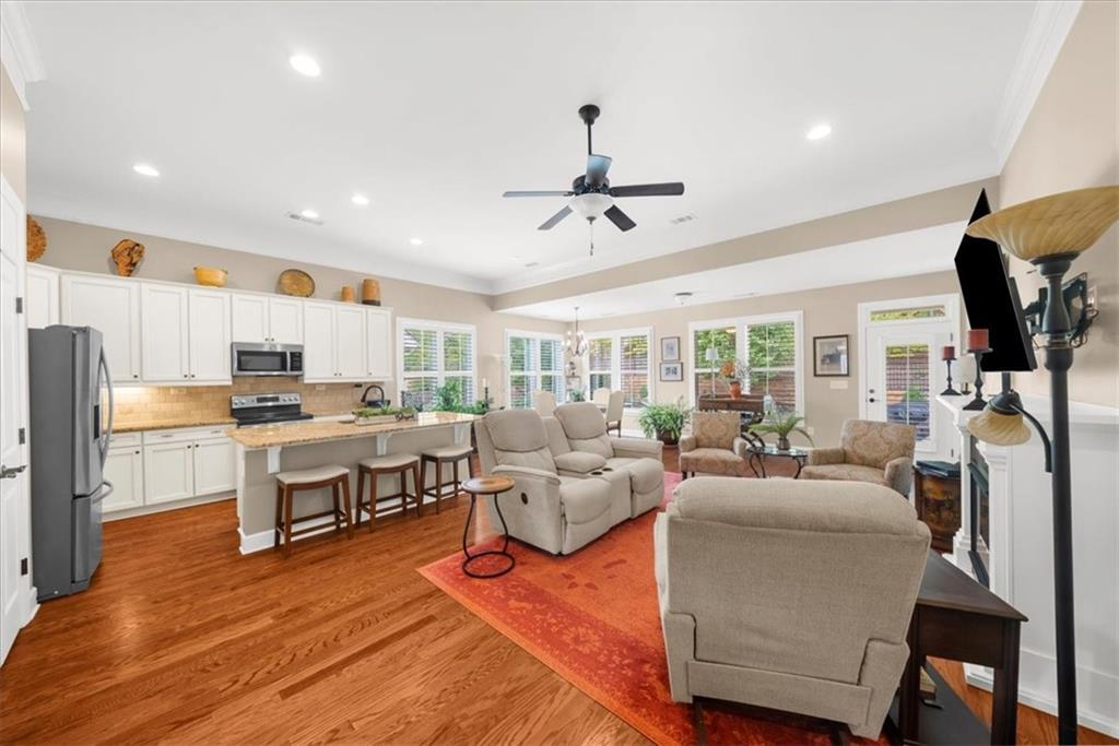 3880 Sweet Magnolia Drive Southwest Gainesville, GA 30504 - Photo 6 of 56 a living room with fireplace furniture and a large window