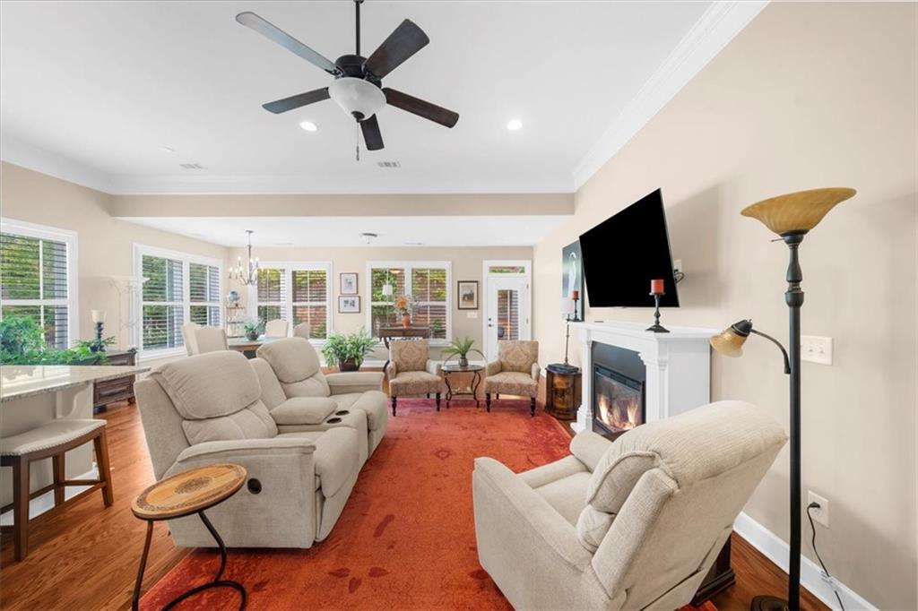 3880 Sweet Magnolia Drive Southwest Gainesville, GA 30504 - Photo 9 of 56 a living room with furniture a fireplace and a flat screen tv