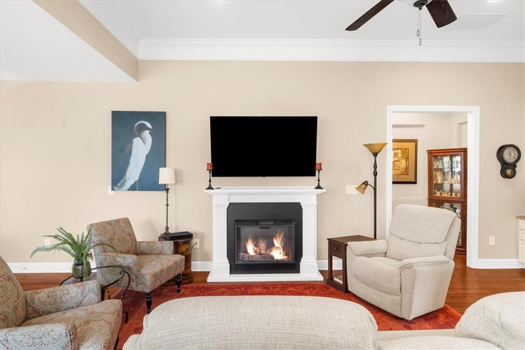 3880 Sweet Magnolia Drive Southwest Gainesville, GA 30504 - Photo 10 of 56 a living room with furniture a flat screen tv and a fireplace