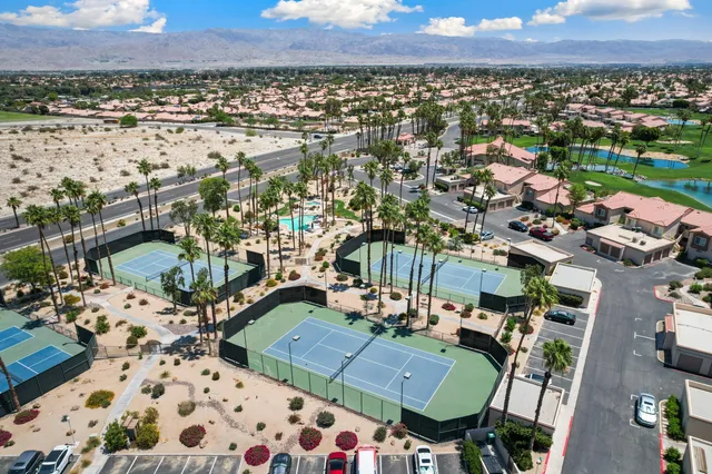 an aerial view of multiple houses with yard