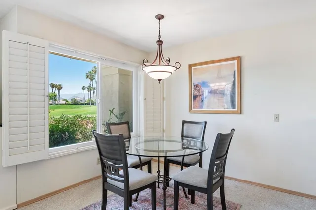 a dining room with furniture and window