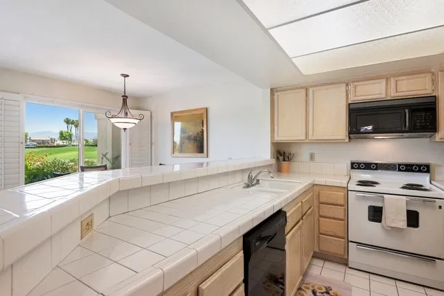 a kitchen with a sink stove and microwave
