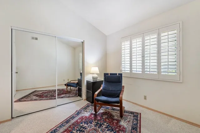 a living room with furniture and a floor to ceiling window