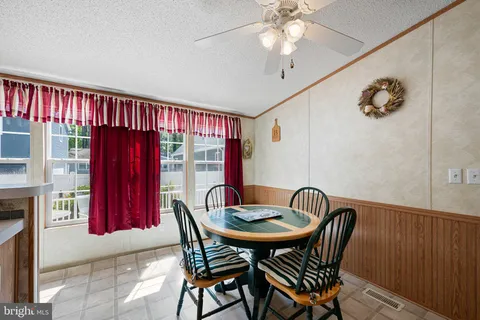 a view of a dining room with furniture and window