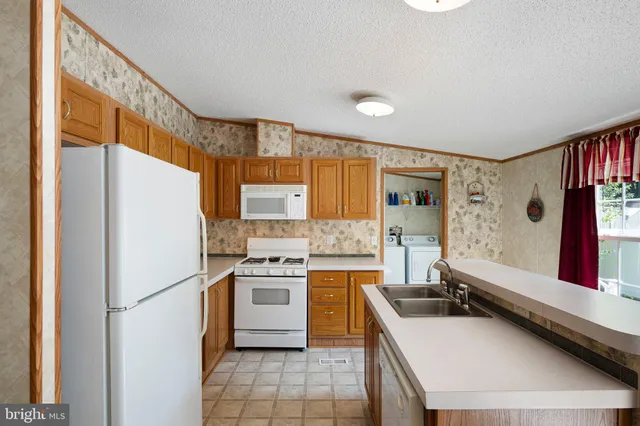a kitchen with a stove a refrigerator and a sink