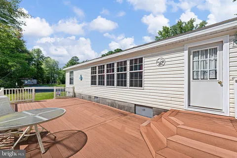 a balcony with table and chairs