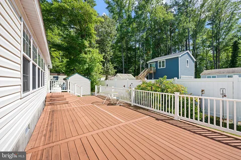 a view of a wooden deck with trees
