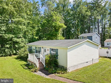 a aerial view of a house with a yard table and chairs