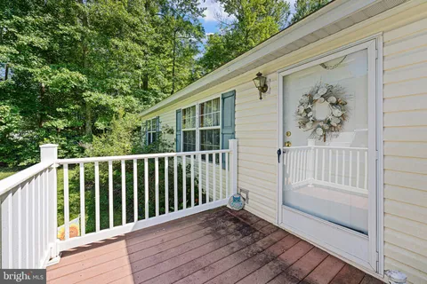 a view of backyard with deck and wooden floor