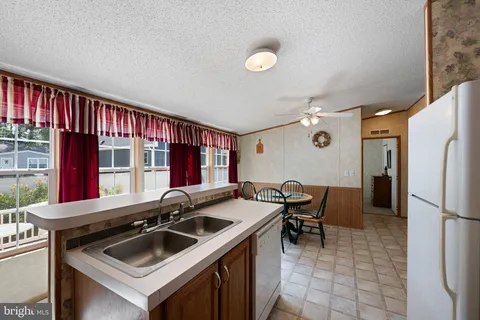 a kitchen that has a sink and a stove in it