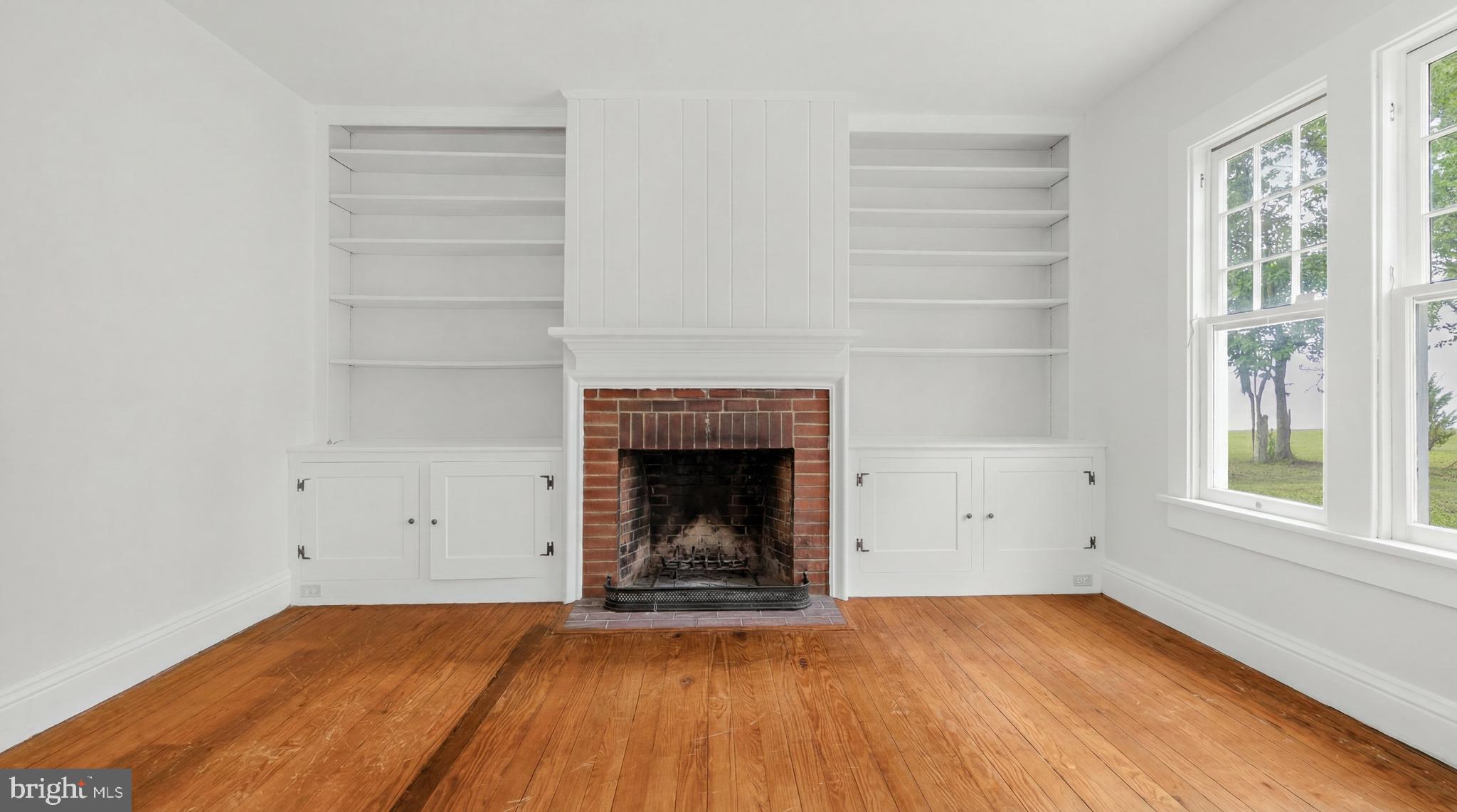 500 Nesbit Road Queenstown, MD 21658 - Photo 13 of 53 a view of empty room with wooden floor and a window