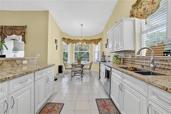 a kitchen with granite countertop lots of counter top space and stainless steel appliances