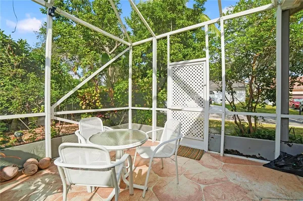 a view of a chair and tables in the balcony