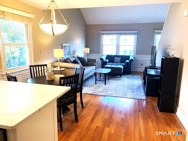 65 Ellsworth Street, Unit 302 Bridgeport, CT 06605 - Photo 11 of 40 a living room with furniture and a wooden floor
