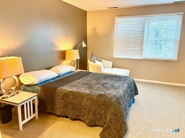 65 Ellsworth Street, Unit 302 Bridgeport, CT 06605 - Photo 20 of 40 a bedroom with a bed and wooden floor