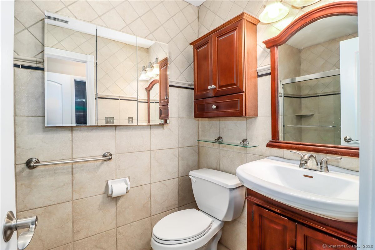 65 Ellsworth Street, Unit 302 Bridgeport, CT 06605 - Photo 27 of 40 a bathroom with a sink a toilet and shower