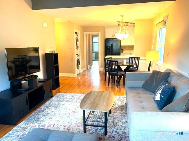 65 Ellsworth Street, Unit 302 Bridgeport, CT 06605 - Photo 8 of 40 a living room with furniture and a flat screen tv