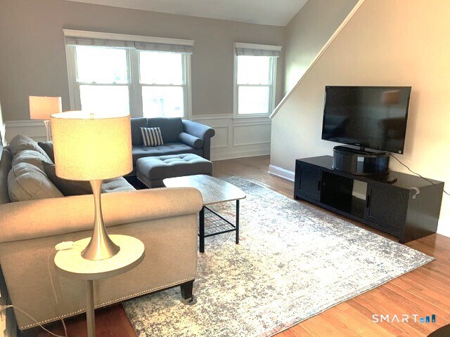 65 Ellsworth Street, Unit 302 Bridgeport, CT 06605 - Photo 10 of 40 a living room with furniture and a flat screen tv