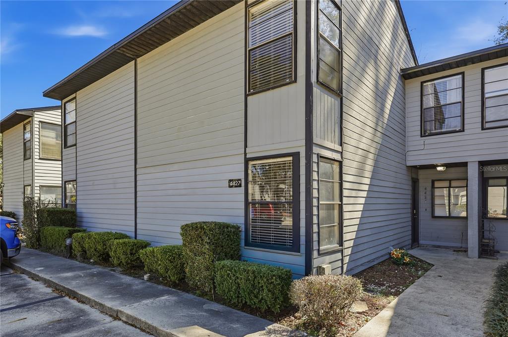 a view of a brick house with a large windows