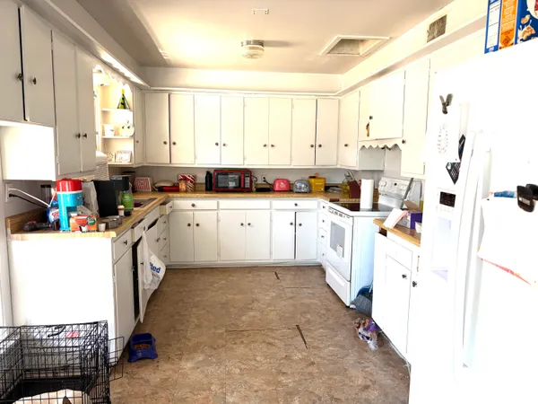 a kitchen with a white cabinets and white appliances