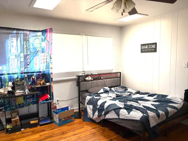 a bed sitting in a bedroom next to a window