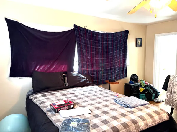 a bed sitting in a bedroom next to a lamp and dresser