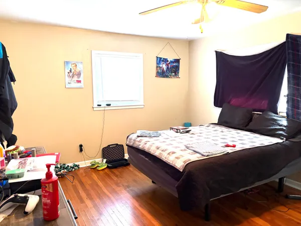 a bedroom with a bed and a dresser