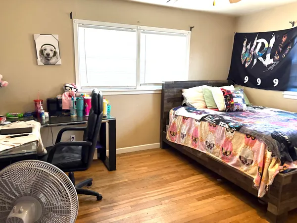 a bedroom with a bed and a window