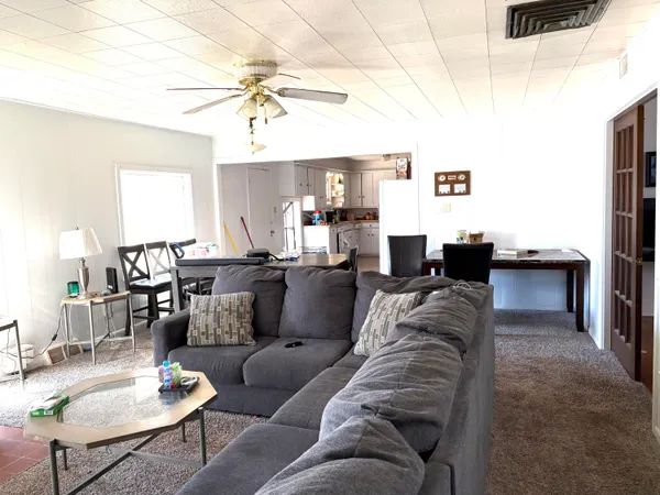 a living room with furniture and a chandelier
