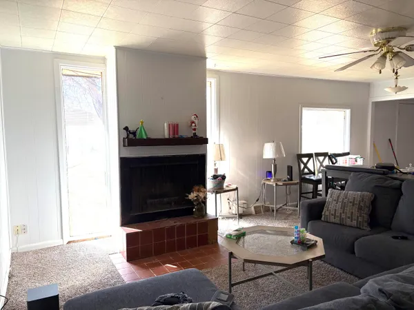 a living room with furniture a flat screen tv and a fireplace