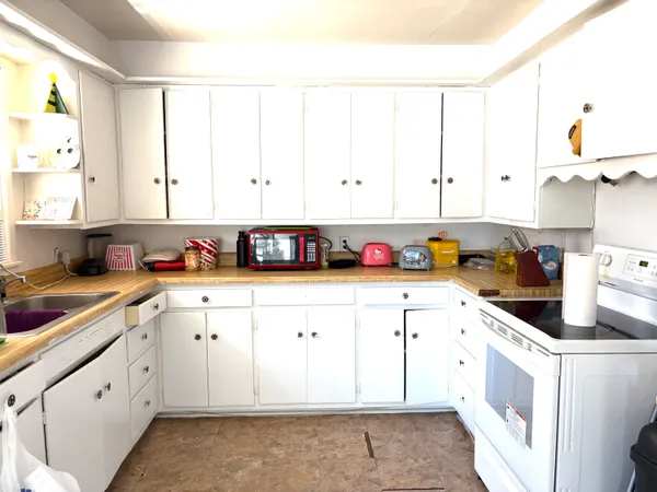 a kitchen with stainless steel appliances cabinets a sink and a window