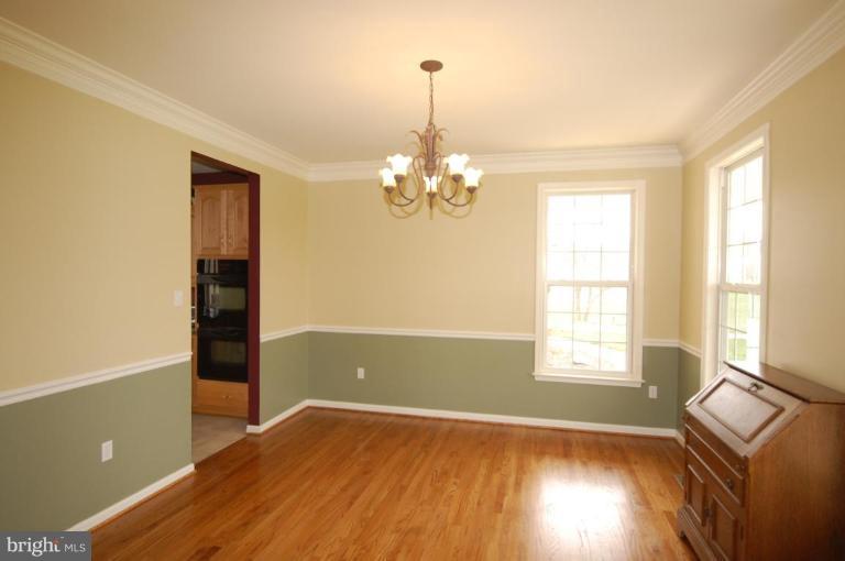 7791 Dollyhyde Road Mount Airy, MD 21771 - Photo 3 of 16 wooden floor in an empty room with a window