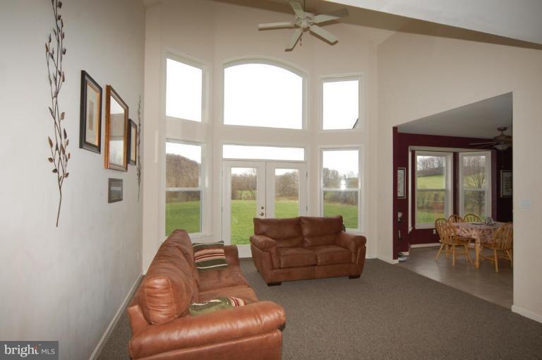 7791 Dollyhyde Road Mount Airy, MD 21771 - Photo 4 of 16 a living room with furniture and a large window