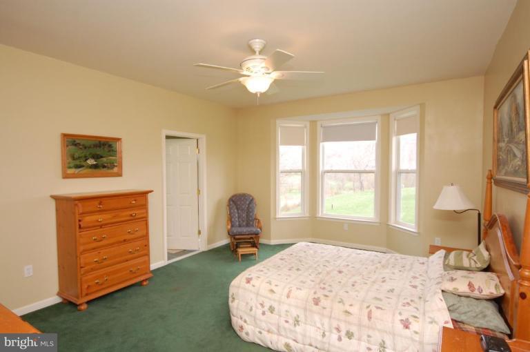 7791 Dollyhyde Road Mount Airy, MD 21771 - Photo 7 of 16 a bedroom with a bed and a dresser