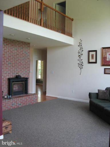 7791 Dollyhyde Road Mount Airy, MD 21771 - Photo 10 of 16 a view of a livingroom with an empty space and a fireplace