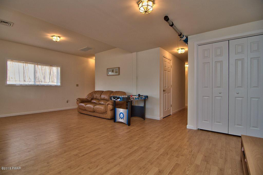 2312 Brookfield Road Lake Ariel, PA 18436 - Photo 18 of 26 a living room with furniture and a wooden floor