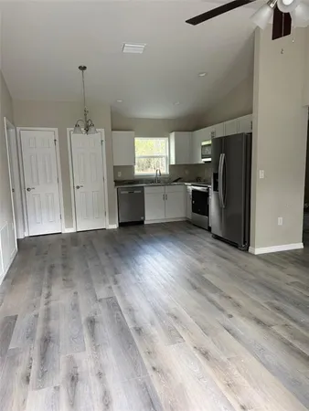 a view of kitchen with furniture and wooden floor