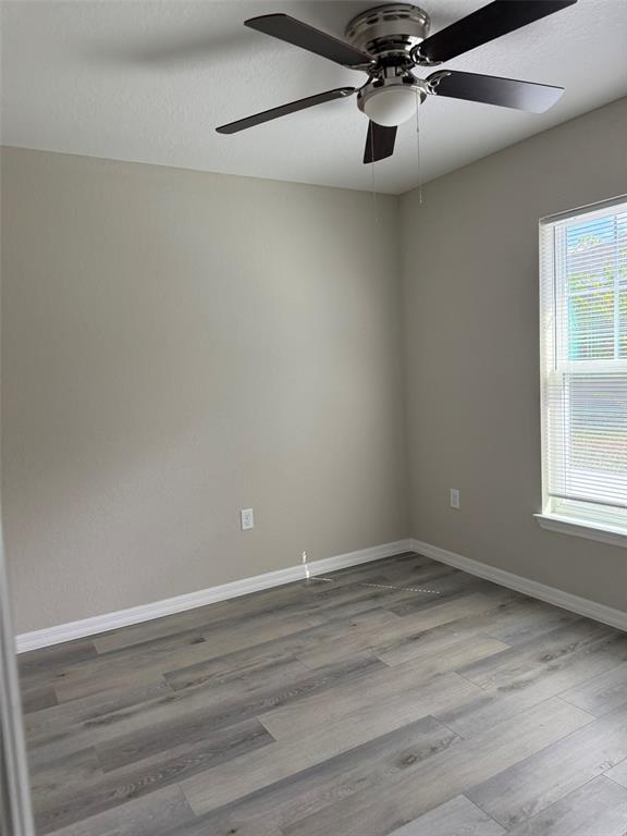 9543 North Travis Drive, Unit A Citrus Springs, FL 34434 - Photo 8 of 15 a view of an empty room with wooden floor and a window