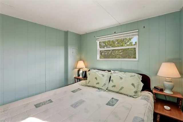 a bedroom with a bed and a lamp