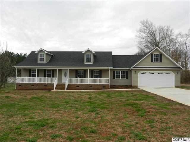 7595 Woodleaf Road Woodleaf, NC 27054 - Photo 1 of 16 a front view of a house with a yard