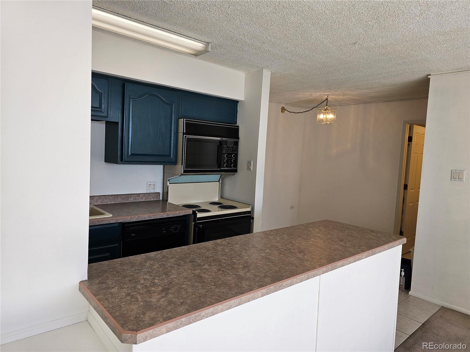 1020 15th Street, Unit 33B Denver, CO 80202 - Photo 11 of 48 a kitchen with stainless steel appliances granite countertop a sink and a stove