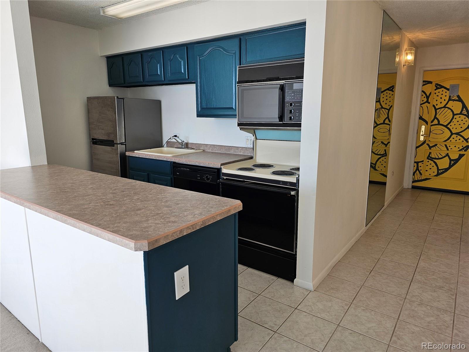 1020 15th Street, Unit 33B Denver, CO 80202 - Photo 14 of 48 a kitchen with stainless steel appliances a sink stove and refrigerator