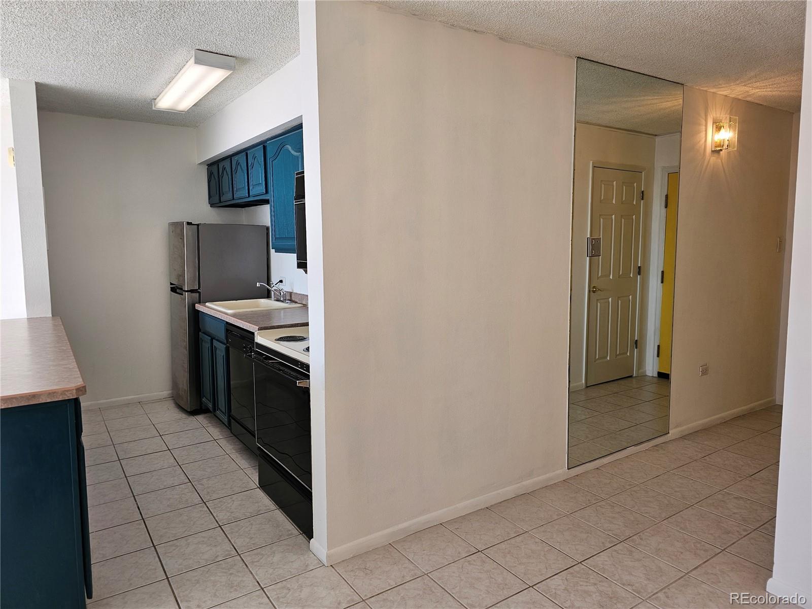 1020 15th Street, Unit 33B Denver, CO 80202 - Photo 15 of 48 a kitchen with a sink and a stove top oven