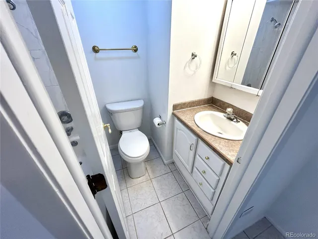 a white toilet sitting next to a bathroom sink