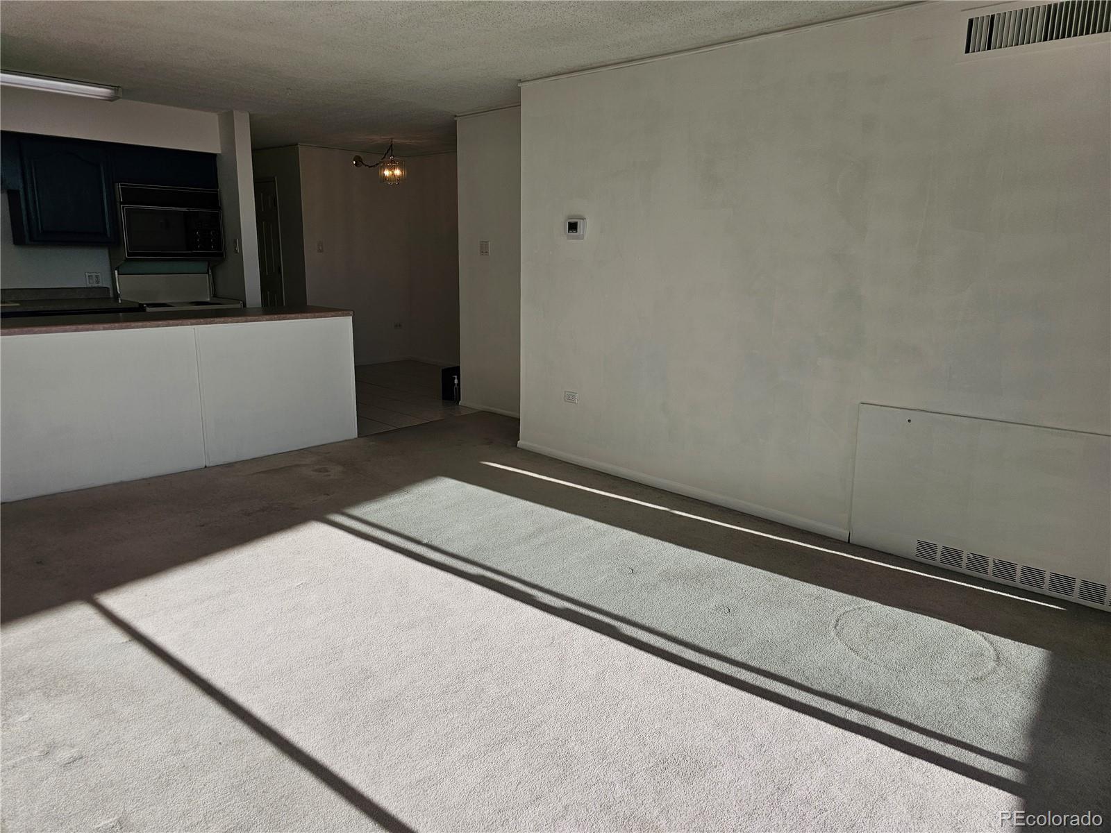 1020 15th Street, Unit 33B Denver, CO 80202 - Photo 24 of 48 a view of an empty room with wooden floor