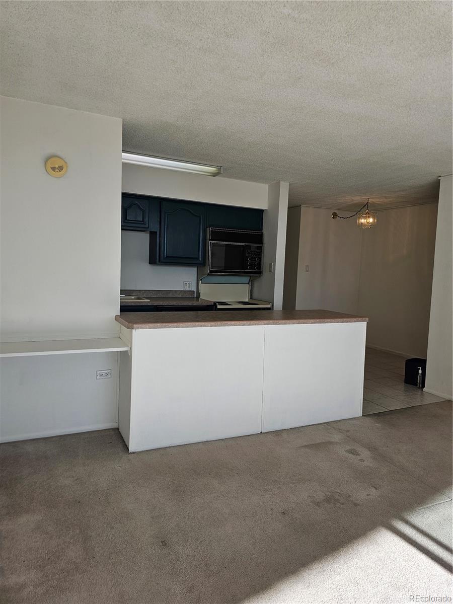 1020 15th Street, Unit 33B Denver, CO 80202 - Photo 25 of 48 a view of an empty room with a fireplace and cabinet