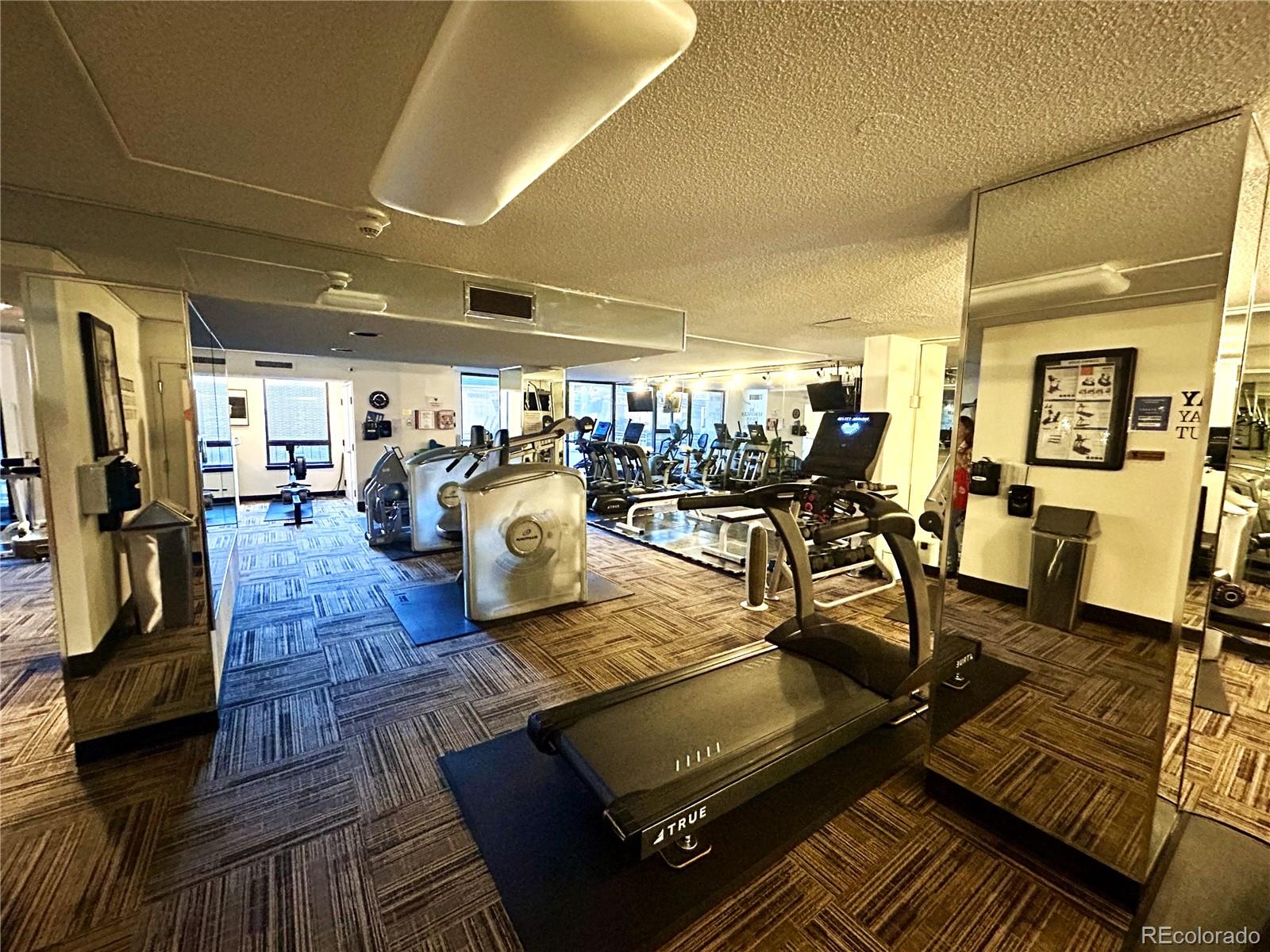 1020 15th Street, Unit 33B Denver, CO 80202 - Photo 34 of 48 a gym room with lots of chairs and a table