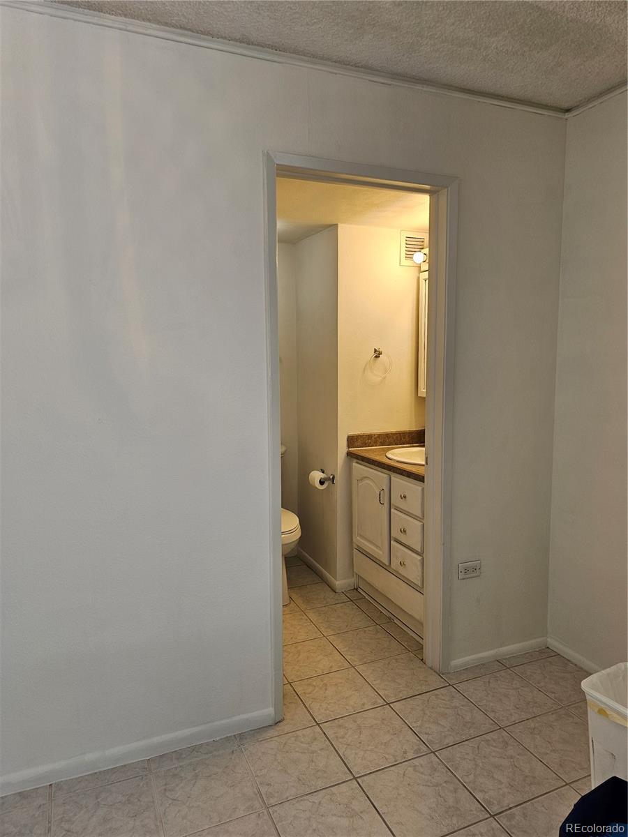 1020 15th Street, Unit 33B Denver, CO 80202 - Photo 5 of 48 a bathroom with a granite countertop sink and a toilet