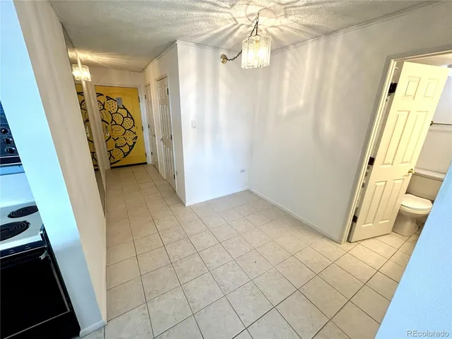 a kitchen with a stove refrigerator and microwave
