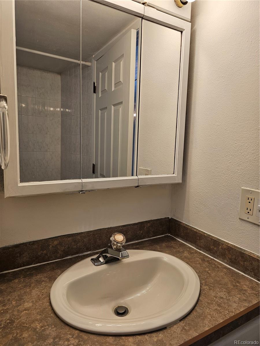 1020 15th Street, Unit 33B Denver, CO 80202 - Photo 10 of 48 a bathroom with a sink and a mirror